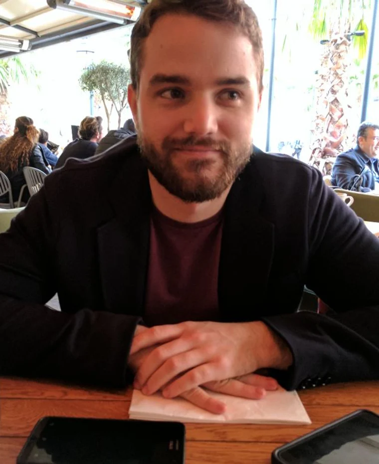 Michael Ryan Thompson sitting at a café table